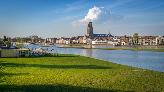 A scenic view of the town of Deventer along a river in the Netherlands