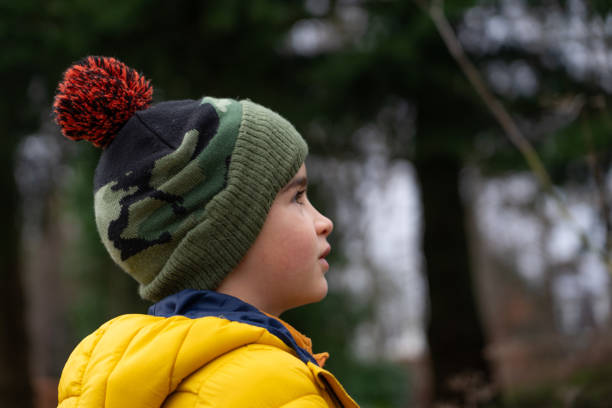 istock Boy in profile with woolen hat and coat in nature 1921903234
