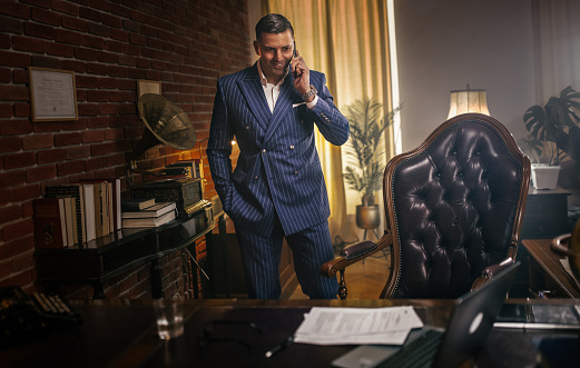 Businessman reading documents and uses the phone and computer in the office