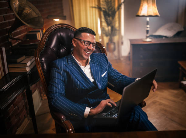 istock Businessman reading documents and uses the phone and computer in the office 1921925149