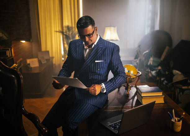 istock Businessman reading documents and uses the phone and computer in the office 1921925154