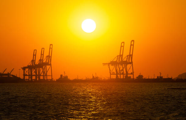 Silhouette of a cargo port image , Cargo ports are facilities that are used to load and unload cargo from ships
