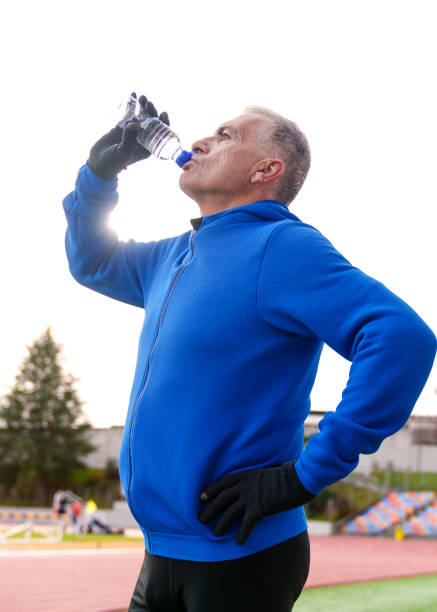 istock Elderly Athlete Taking a Water Break During Track Workout 1921945675