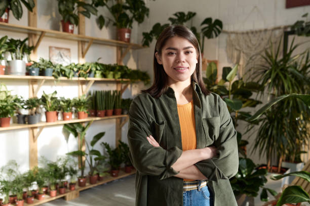 istock Young Woman Confidently Posing in Plant Store 1921978381