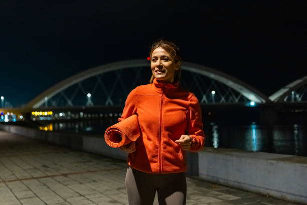 istock Happy young woman going for a night yoga workout 1921983092