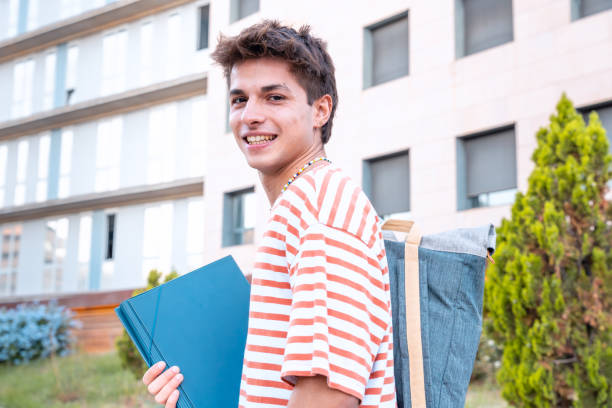 caucasian Student sitting on campus with a folder leaving class. University life concept.