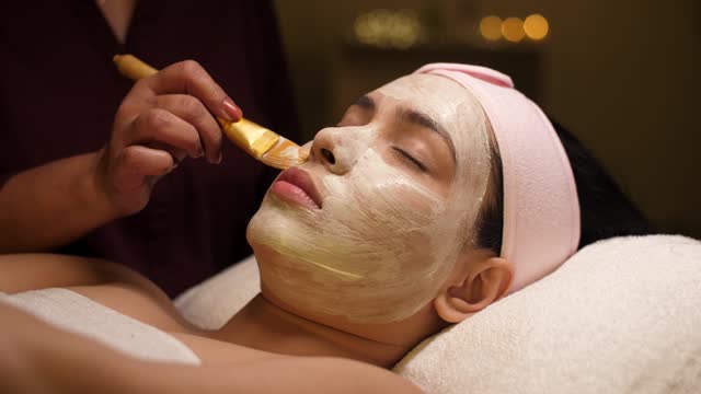Applying avocado face mask with a brush - spa treatment, relaxing routine, detoxification, break from routine, acne treatment