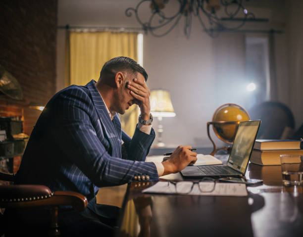 istock shot of a young businessman looking stressed while working in a office 1922016854