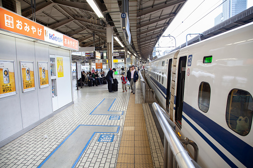 31st March 2012 - Tokyo, Japan.
Shinkansen N700 bullet train at a Tokyo train station with people on the platform.