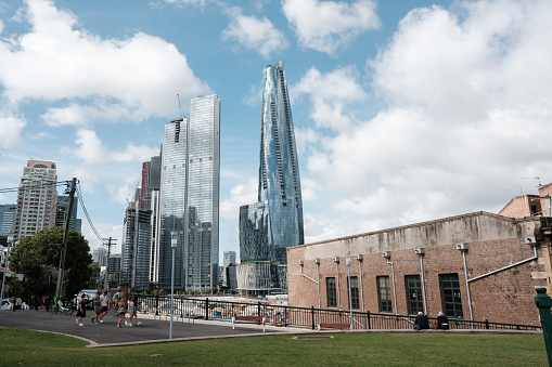 Sydney, Australia - January 07,  2024: Sydney Crown Casino with neighbouring buildings at Barangaroo. A smaller old brick building in the foreground is used as office space.