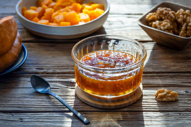 istock Sunlit Pumpkin and walnuts jam on the wooden table with ingredients 1922037568