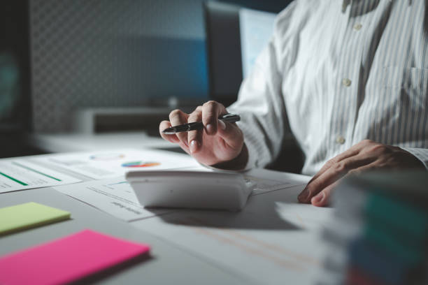 istock Numerical data is being presented for the accountant to calculate, male accountant working about financial with calculator at her office, Savings, Finances and economy concept, 1922055883