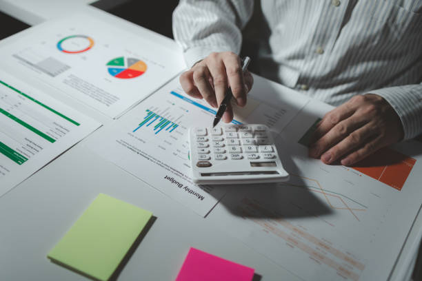 istock Numerical data is being presented for the accountant to calculate, male accountant working about financial with calculator at her office, Savings, Finances and economy concept, 1922056394