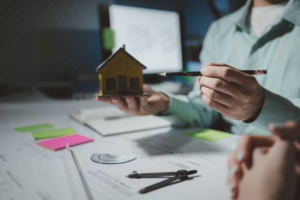 istock Architects are reviewing plans together, Construction and structure of engineer or architect meeting for project working with partner and tools on model building and blueprint in working site 1922067241