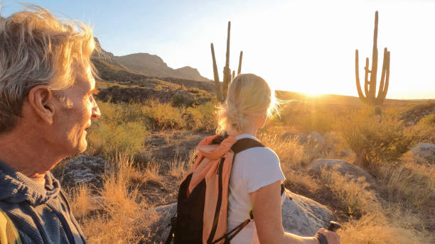 istock Mature couple hike through desert landscape 1922070348