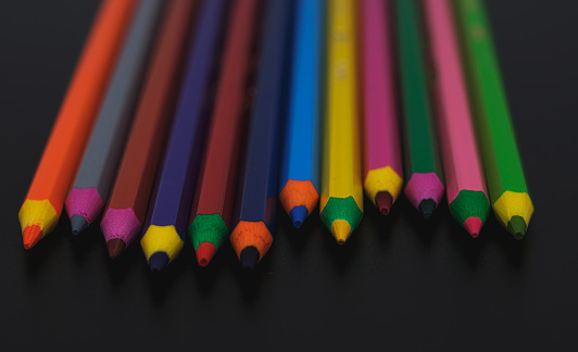 Pencil in a row on pink background