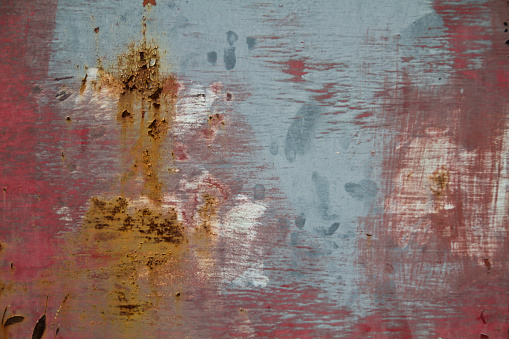 Rustic Decay: A close-up of a weathered surface in Louisville, Kentucky, showcasing a rich patina of rust and flaking paint. The chaotic and textured pattern tells the story of material decay and the relentless forces of nature.