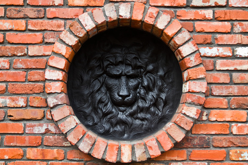 Regal Lion's Head Sculpture in Circular Frame on Brick Wall, Louisville, Kentucky
