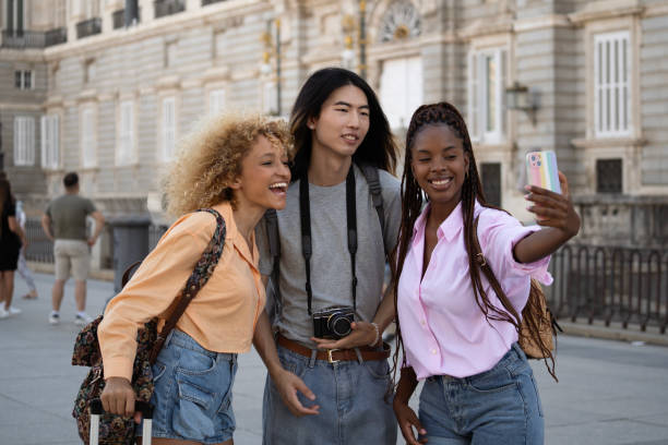 Multiethnic group of tourists friends taking a selfie in Madrid city Multiethnic group of tourists friends taking a selfie in Madrid city. selfie madrid photos stock pictures, royalty-free photos & images