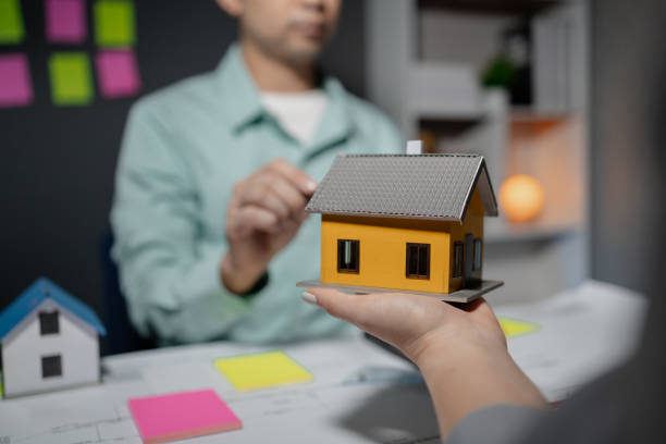istock Commercial buildings are being evaluated by architects on what type of construction they need to be built, Engineers are designing a structure according to blueprints, 1922092927