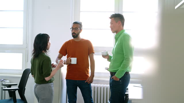 Business people talking during coffee break in startup office