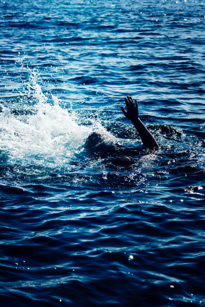 istock Drowning man in sea asking for help with raised arms 1922121133