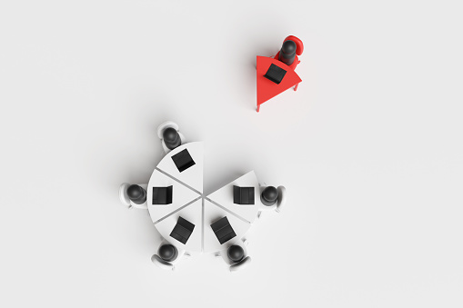 Group of office employees working at a round pie chart shaped table with a single desk being isolated. Illustration of the concept of workplace bullying and lack of teamwork