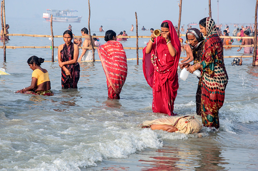 24 parganas south, west Bengal. The Hindu devotees are busy to taking a Holi bath in river Ganga in the morning at Gangasagar.