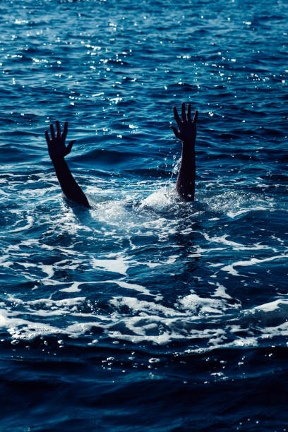 istock Drowning man in sea asking for help with raised arms 1922131233