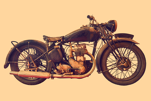 Sepia toned side view image of an English vintage motorcycle