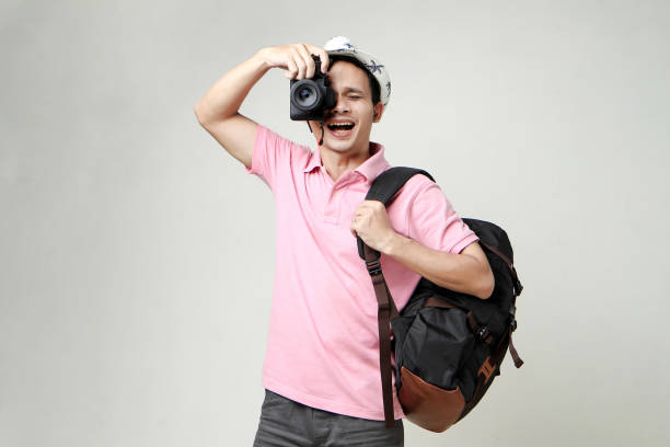A man takes a photo on a vintage film camera in nature, copy space.