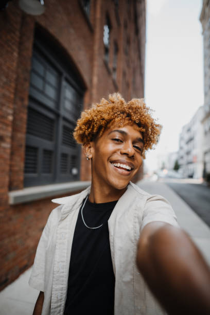 istock POV Vertical photo of multiracial guy smiling while making selfie by the camera 1922159992