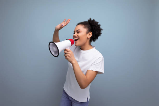 istock young hispanic brunette woman dressed in a white t-shirt shouting a message through a megaphone 1922165519