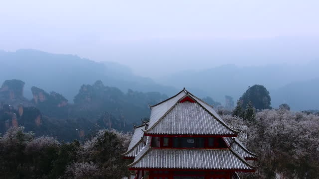 Drone view of the snow-capped avatar mountains with Chinese pagoda on the top of Zhangjiajie National Park