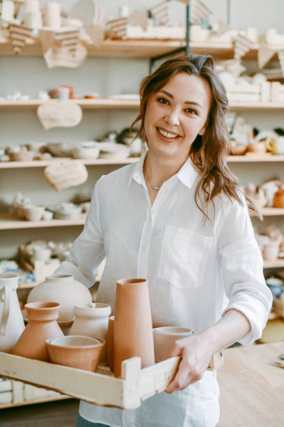 istock A female potter holds a box with raw clay products 1922167158