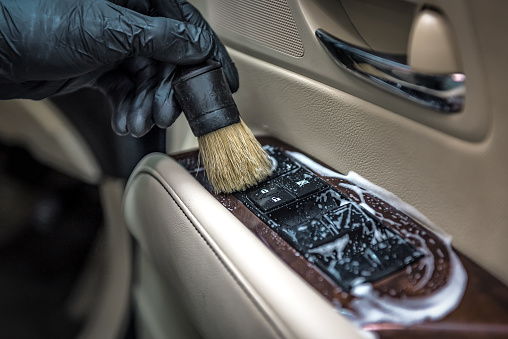Specialist cleaning car with sud and brush. Car detailing. Selective focus. Car detailing. Cleaning with brush. Carwash and cleaning solution concept