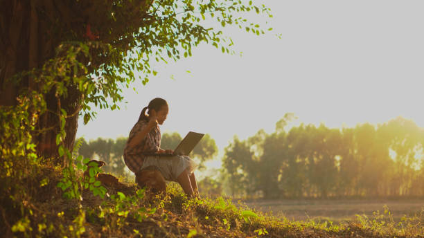 istock A young gir playing with her dog at under the big tree. 1922180564