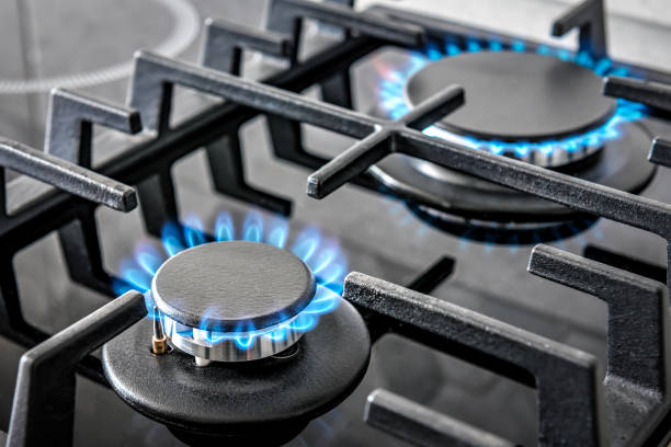 Modern kitchen stove cook with burning blue flames. Industrial theme
