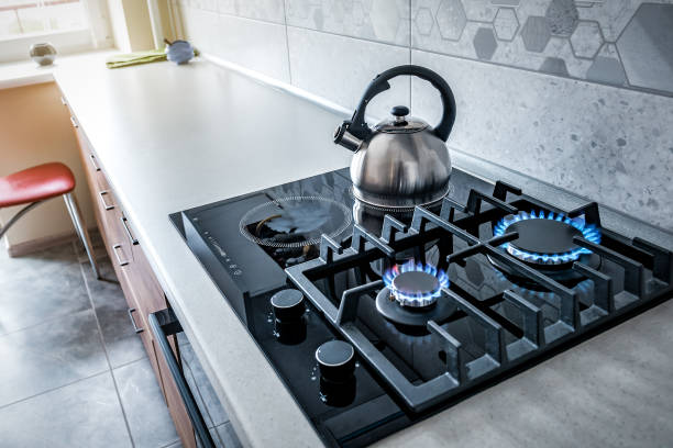 istock Steel kettle with whistle on modern burning gas stove 1922190273