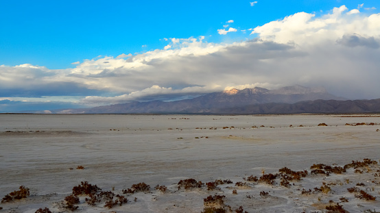 Desert at sunset and thunderclouds against the backdrop of the Guadalupe Mountains in New Mexico