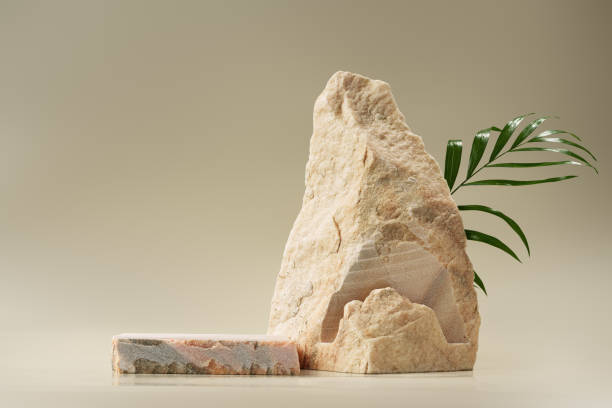 istock Granite stone with branch green leaf on beige background 1922197355