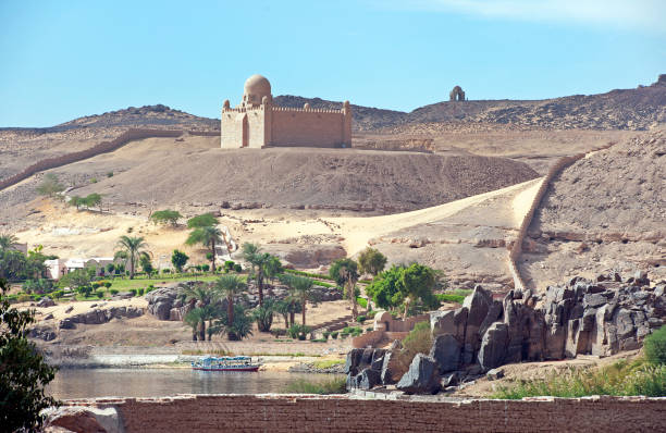 Biblical scene with the Aga Khan mausoleum and river's edge at The Cataracts of the River Nile, Aswan, River Nile, Egypt stock photo