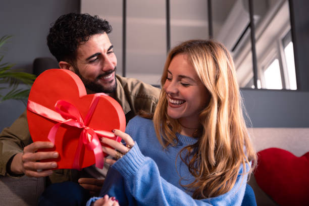 istock Loving young couple with heart-shaped gift box. Valentine's Day Celebration 1922215432
