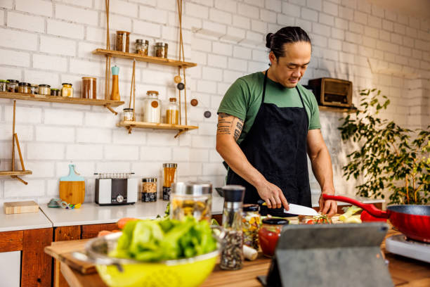 istock Chinese man prepares vegetables for frying 1922217634