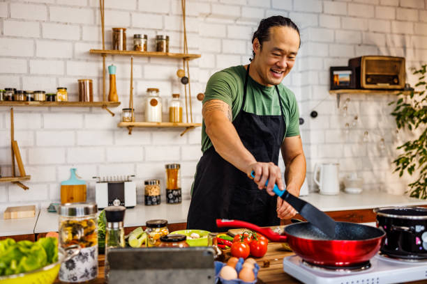 istock Smiling Chinese man frying vegetables 1922218174