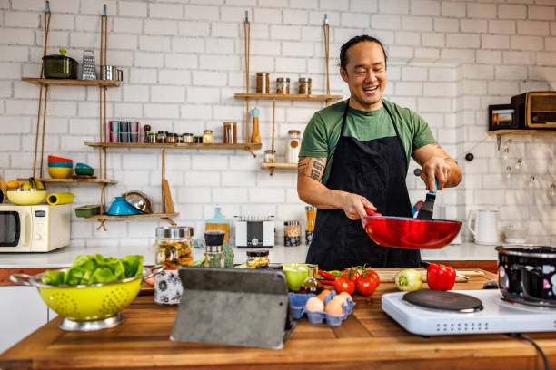 istock Handsome man prepares healthy meal at home 1922218200