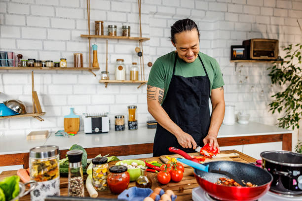 istock Handsome man chopping red paprika 1922219768