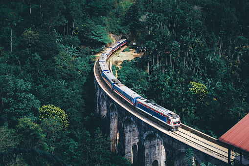 Train in Sri Lanka on Nine Arch Bridge. Railway to Ella from Kandy. Country tourism. Green forest and jungle. Rail travel in Ceylon. Beautiful landscape view of hill and mountain tunnel.