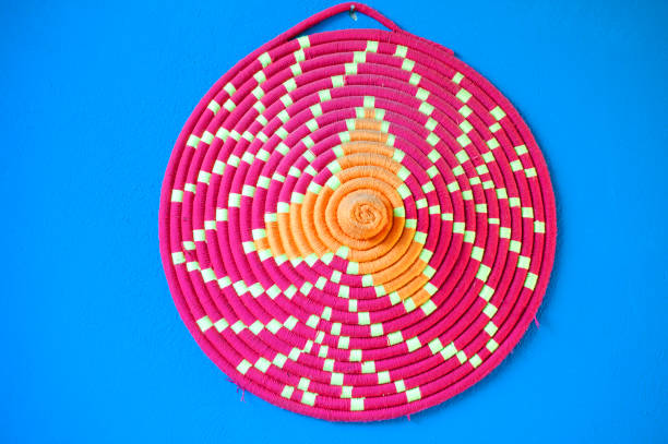 istock Circular pink basketware illustrates the highly decorative patterns and creative applications typify the colours, designs and traditions of a Nubian Village, Aswan, River Nile, Egypt 1922223943