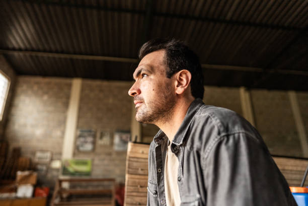 istock Contemplative farmer looking away at a warehouse 1922229290